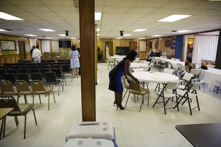 Parishioners clean a room in the basement where the killing of the pastor and eight others occurred in a mass shooting Wednesday, following a service at Emanuel African Methodist Episcopal Church in Charleston, in this June 21, 2015, file photo. REUTERS/David Goldman/Pool