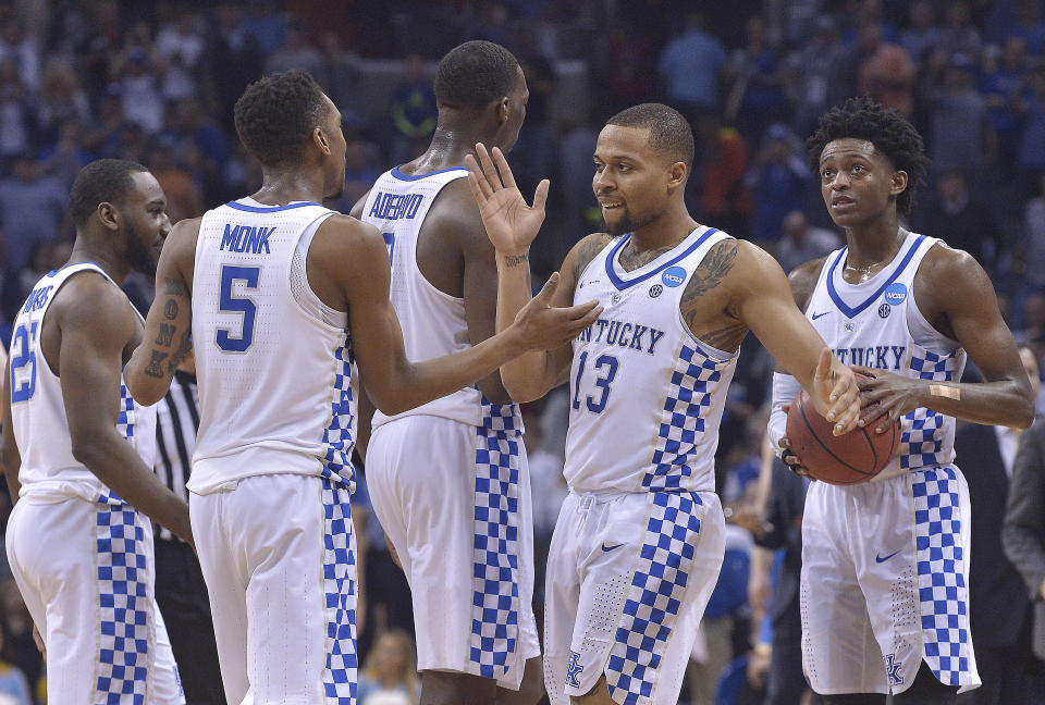 Members of the Kentucky team celebrate after an NCAA college basketball tournament South Regional semifinal game against UCLA, Friday, March 24, 2017, in Memphis, Tenn. Kentucky won 86-75. (AP Photo/Brandon Dill)