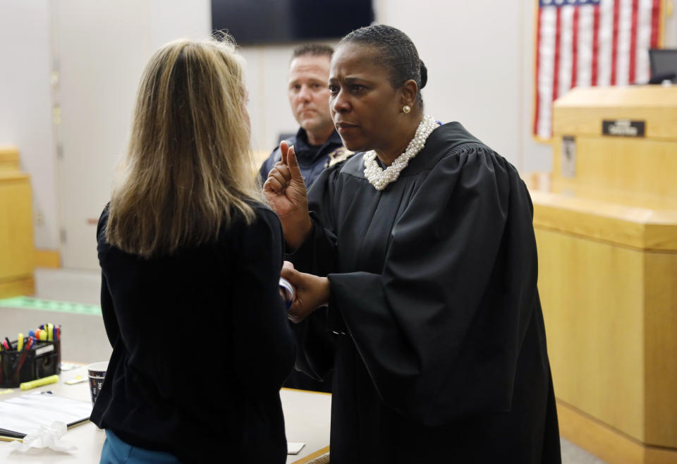 State District Judge Tammy Kemp gives advice and encouragement to former Dallas Police Officer Amber Guyger, left, before Guyger left for jail, Wednesday, Oct. 2, 2019, in Dallas. Guyger, who said she mistook neighbor Botham Jean's apartment for her own and fatally shot him in his living room, was sentenced to a decade in prison. (Tom Fox/The Dallas Morning News via AP, Pool)