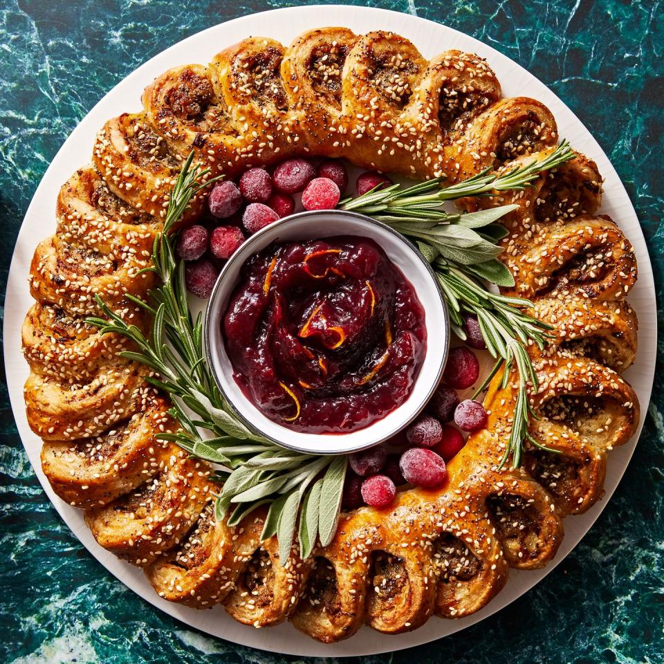 sausage roll wreath with cranberry sauce for dipping