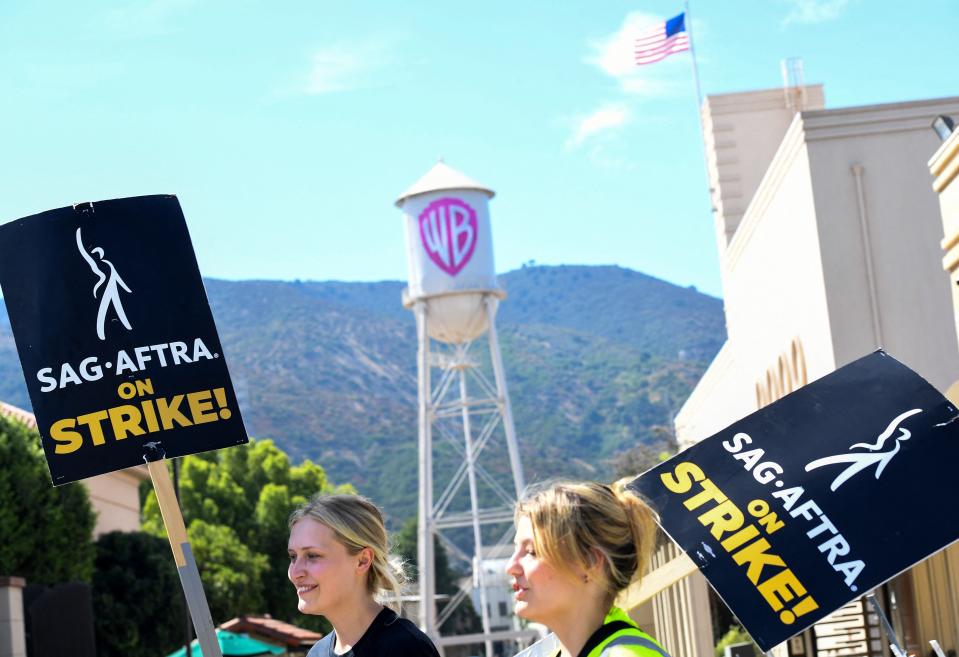 Members of the Writers Guild of America and the Screen Actors Guild walk a picket line outside of Warner Bros Studio in Burbank, California, on July 26, 2023. Tens of thousands of Hollywood actors went on strike at midnight July 14, 2023, effectively bringing the giant movie and television business to a halt as they join writers in the first industry-wide walkout for 63 years.