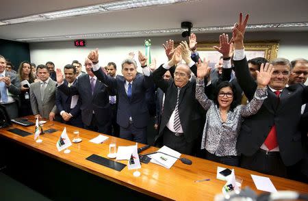 Congressman of the Brazilian Democratic Movement Party (PMDB) celebrate after announcing that they are withdrawing their support of President Dilma Rousseff's ruling coalition during their National Executive Meeting in Brasilia, Brazil, March 29, 2016. REUTERS/Gregg Newton