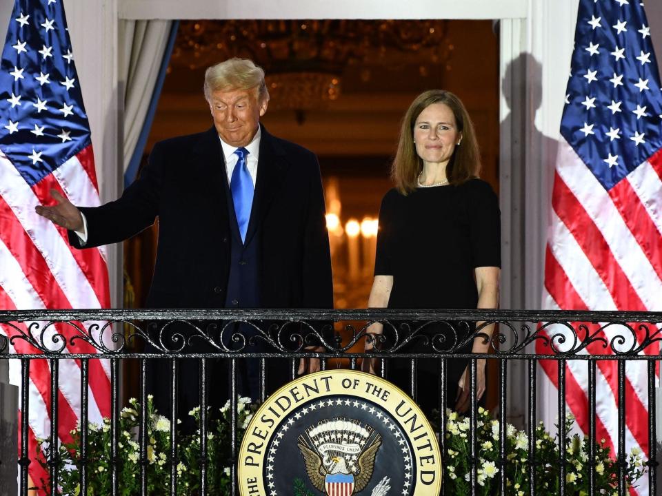 Trump stands with now-Justice Amy Coney Barrett at the White House after she was sworn in on October 26, 2020.