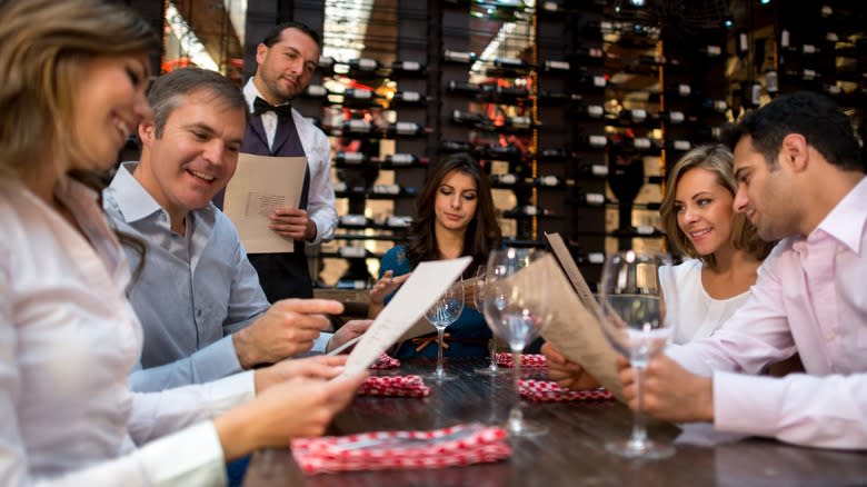 Smiling group looking at menus at a restaurant