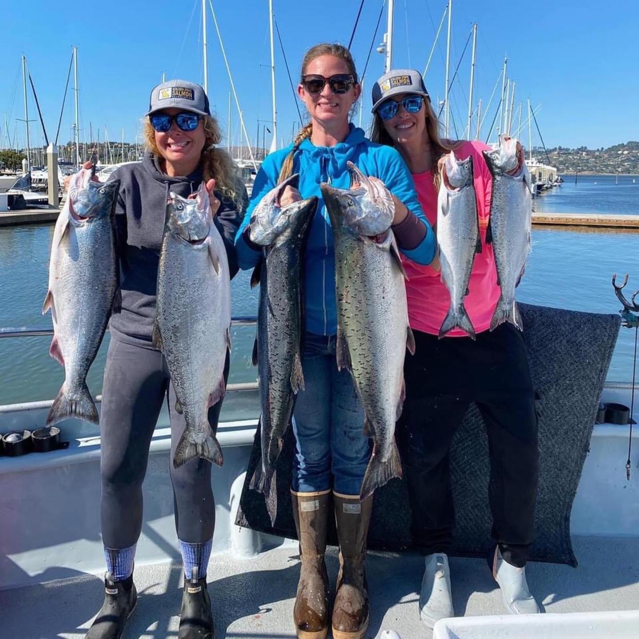 Golden Gate Salmon Association (GSSA) events director Cat Kaiser, along with Tricia Nesler and Annie Nagel display the salmon they caught off Pedro Point aboard the Salty Lady on Aug. All three reached their limit.