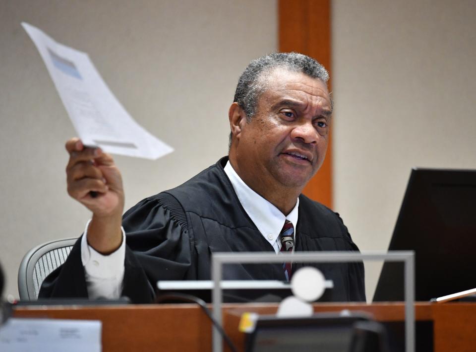 Judge Charles Williams asks attorneys about entering a document as evidence Tuesday during a hearing at the Silvertooth Judicial Center in Sarasota. The Herald-Tribune is seeking to overturn an emergency injunction barring the news organization from publishing the names of two deputies involved in a fatal shooting.