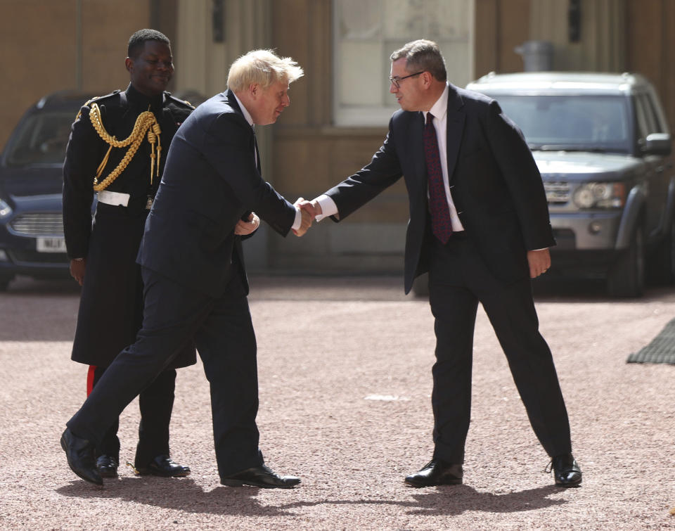 Newly elected leader of the Conservative party Boris Johnson, center, arrives at Buckingham Palace in London for an audience with Queen Elizabeth II where he will be formally invited to become Prime Minister, Wednesday July 24, 2019. Boris Johnson will replace May as Prime Minister later Wednesday, following her resignation last month after Parliament repeatedly rejected the Brexit withdrawal agreement she struck with the European Union. (Yui Mok/pool via AP)