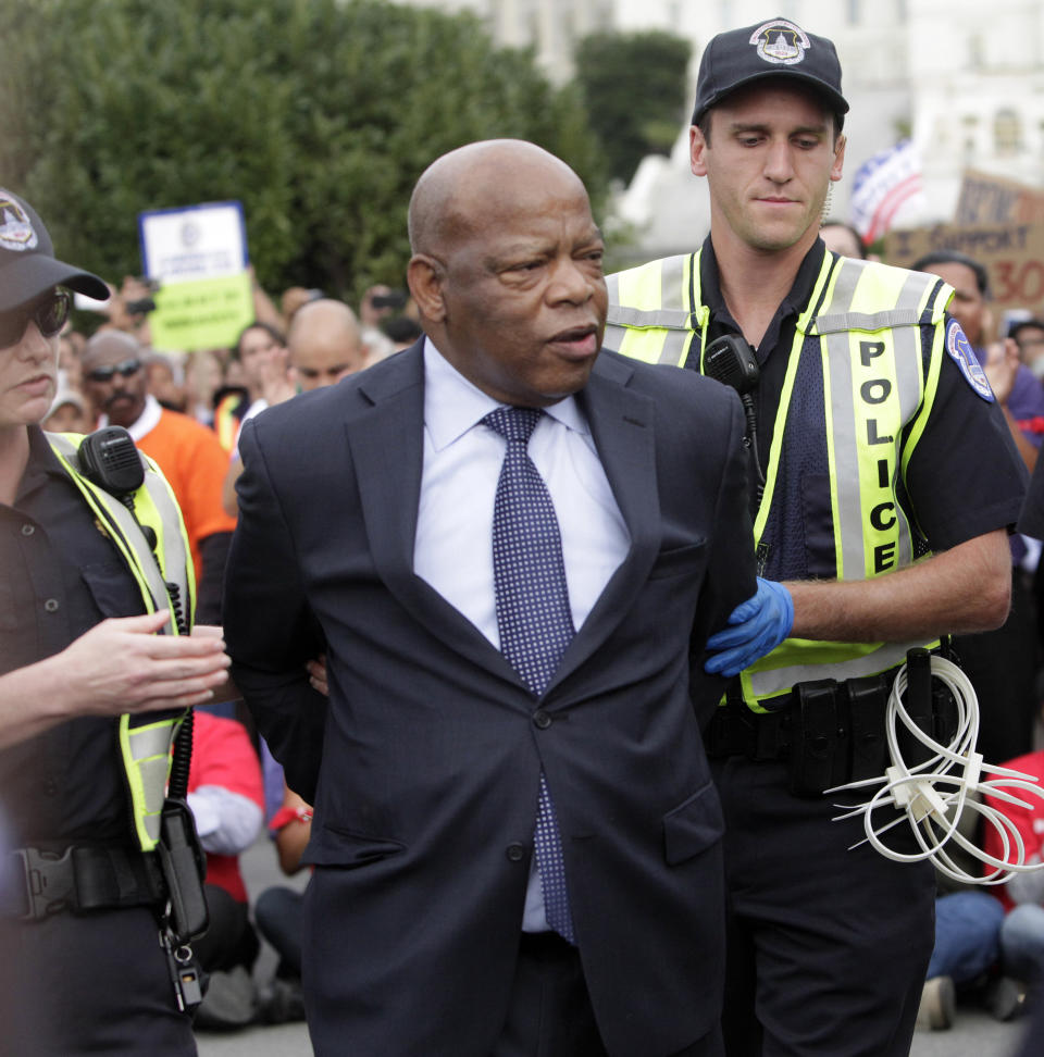 Representaive John Lewis (D-GA) is arrested on Capitol Hill in an act of civil disobedience to encourage support of immigration reform, October 8, 2013 on The National Mall in Washington DC as thousands rallied in support of immigration reform on the National Mall in Washington DC. The demonstrators called on Congress to adopt an immigration law that would allow the nation's 12 million undocumented immigrants the ability to apply for US citizenship. (Photo: Chris Kleponis/AFP via Getty Images)