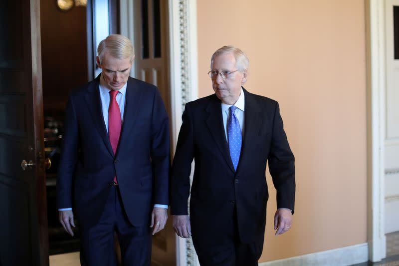 U.S. Senate Majority Leader McConnell walks to the Senate floor with Senator Portman at the U.S. Capitol in Washington