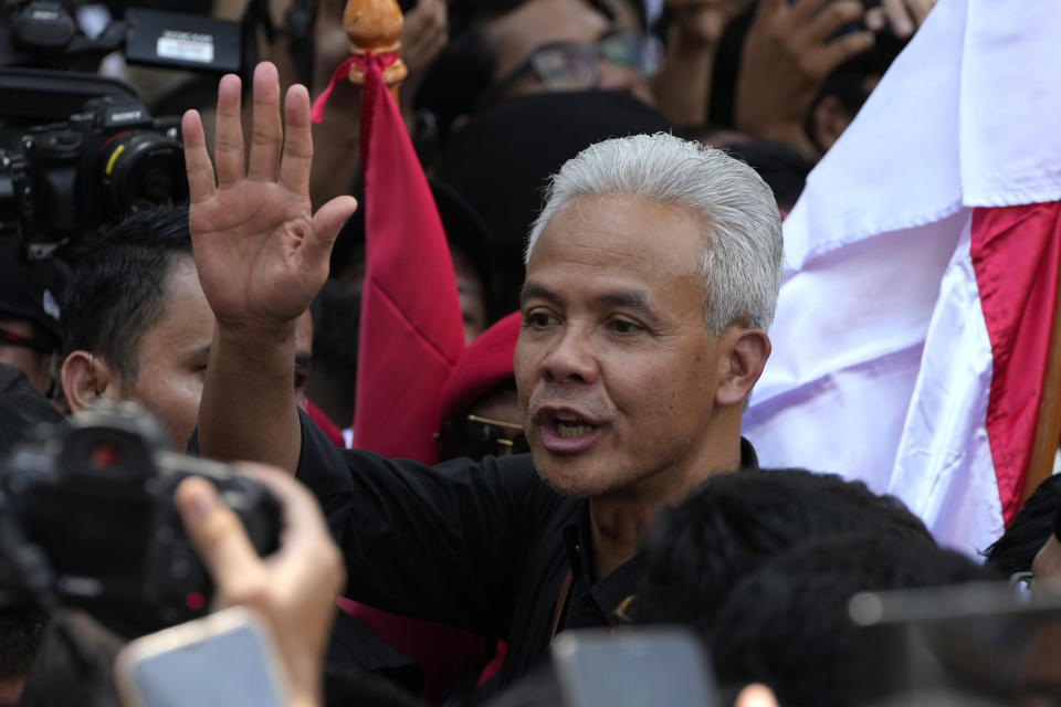 Presidential candidate of the ruling Indonesian Democratic Party of Struggle (PDIP) Ganjar Pranowo greets supporters upon arrival to register his candidacy to run in the 2024 presidential election at the General Election Commission building in Jakarta, Indonesia, Thursday, Oct. 19, 2023. The world's third-largest democracy is set to vote in simultaneously legislative and presidential elections on Feb. 14, 2024. (AP Photo/Achmad Ibrahim)