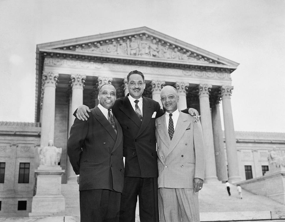 Attorneys who argued Brown v. Board stand together smiling in front of the U. S. Supreme Court Building, after it ruled that segregation in public schools is unconstitutional. Left to right are George E. C. Hayes, Thurgood Marshall and James Nabrit, Jr. (Bettmann)