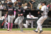 Cleveland Guardians' David Fry, center, scores on a passed ball during the sixth inning of a baseball game against the Chicago White Sox, Sunday, May 12, 2024, in Chicago. (AP Photo/Melissa Tamez)