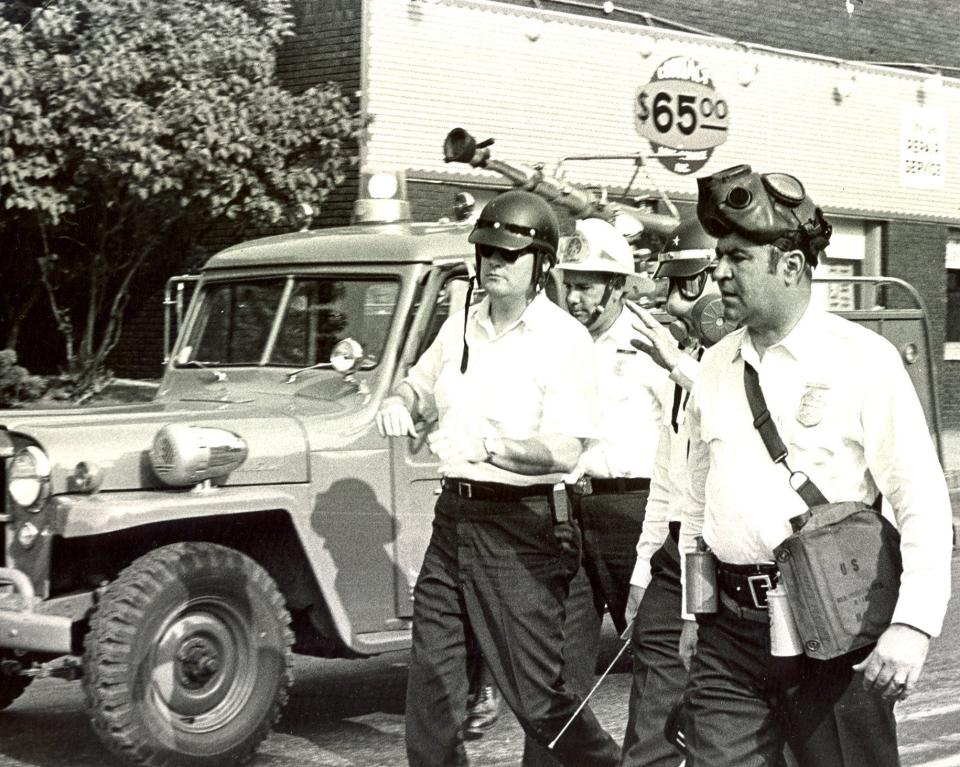 Safety Director James J. Hughes, left, is at command as police prepare to clear High Street on May 22, 1970. With him are Police Chief Dwight Joseph, wearing a gas mask, and Capt. Frank Peterfy (at right), plus an unidentified fire chief. Behind them is the fire division's water turret, which was not used.