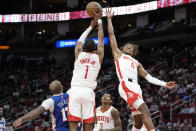 Houston Rockets guard Jalen Green (4) and forward Jabari Smith Jr. (1) leap for a rebound during the first half of an NBA basketball game against the Philadelphia 76ers, Monday, Dec. 5, 2022, in Houston. (AP Photo/Eric Christian Smith)