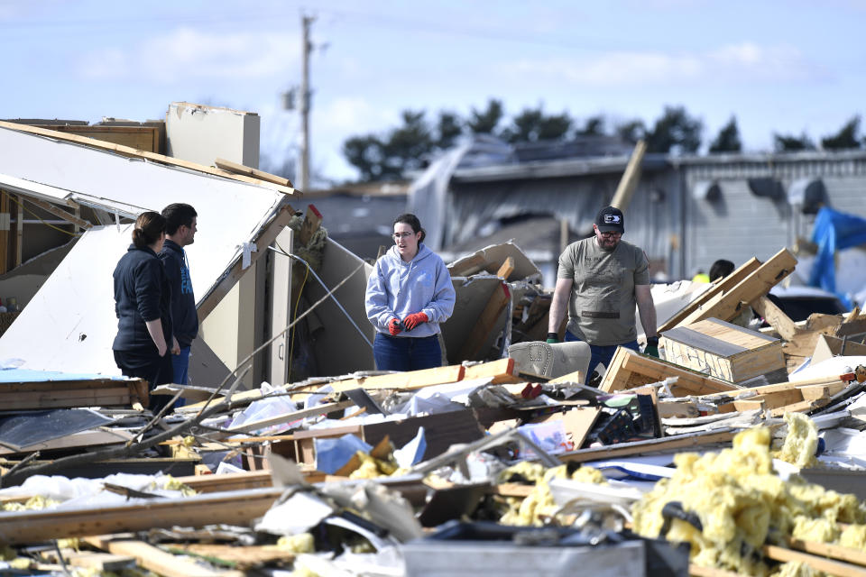 Members of the congregation of the Freedom Life Church pick through the remains of the church in Winchester, Ind., Friday, March 15, 2024, after it was destroyed in severe storms overnight. (AP Photo/Timothy D. Easley)