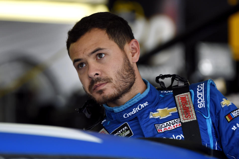 FILE - Kyle Larson climbs into his car for a practice session for a NASCAR Cup Series auto race in Long Pond, Pa., in this Saturday, July 27, 2019, file photo. Larson was banished from NASCAR for all but the first month of his last season, his punishment for using a racial slur while racing online. Rick Hendrick felt the driver paid his penalty and deserved a second chance, one that begins with the season-opening Daytona 500. (AP Photo/Derik Hamilton)