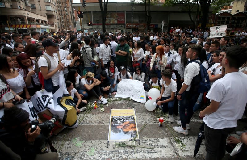 People gather in the street where Dilan Cruz was injured, allegedly by a tear gas canister fired by riot police during the national strike on the previous day, in Bogota