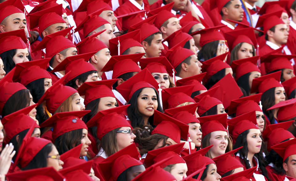 FILE - In this June 7, 2014, file photo, Odessa High School graduates pose for a group portrait prior to the start of the commencement ceremony in Odessa, Texas. Lower-performing students are doing worse in math and reading, dragging down overall results on the Nation’s Report Card. American fourth graders overall posted a slight decline in8 math and a slight gain in reading, while eighth graders saw results fall in both reading and math. That’s according to results released Wednesday on the 2019 National Assessment of Educational Progress, a nationwide test. (Edyta Blaszczyk/Odessa American via AP)