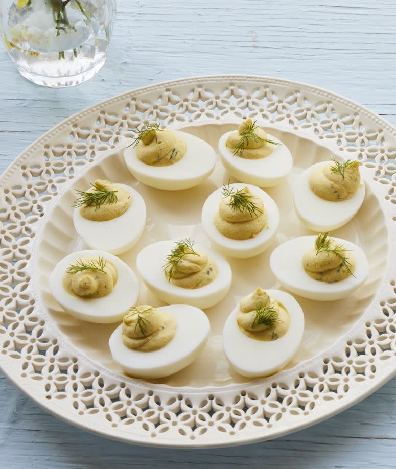 whipped deviled eggs with dill on white detailed plate