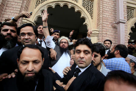 Hafiz Saeed (C) reacts to supporters as he walks out of court after a Pakistani court ordered his release from house arrest in Lahore, Pakistan November 22, 2017. REUTERS/Mohsin Raza