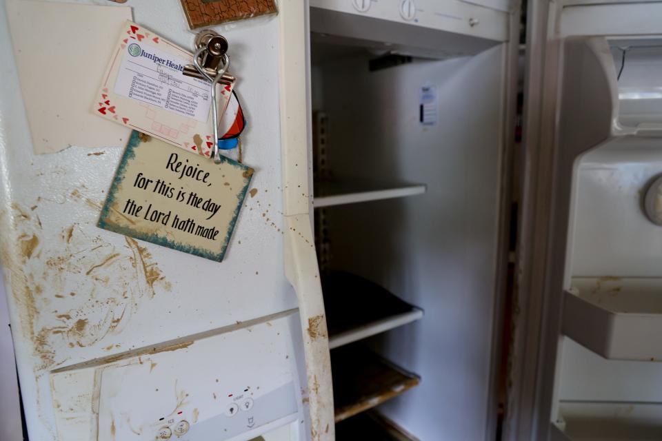 Flooding left a refrigerator covered in river mud in Teresa Watkins' home outside Jackson, Ky.