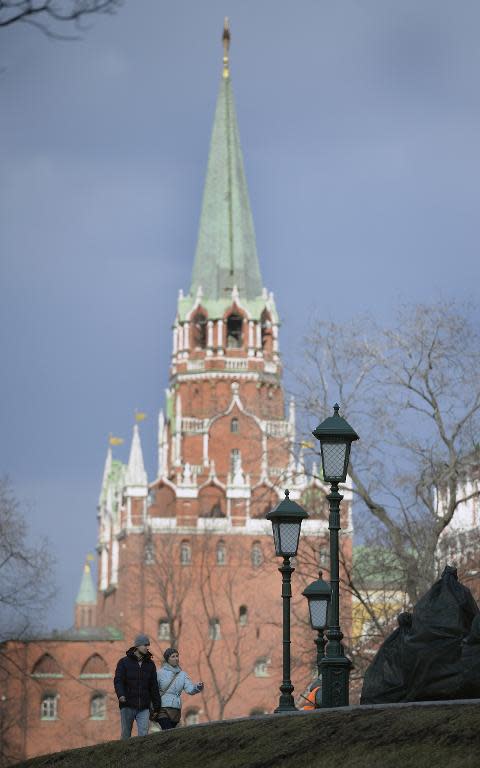 A couple walks outside the Kremlin in Moscow on April 7, 2015