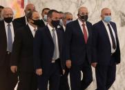 Lebanon's parliament speaker Nabih Berri wears a face mask as he walks at the presidential palace in Baabda