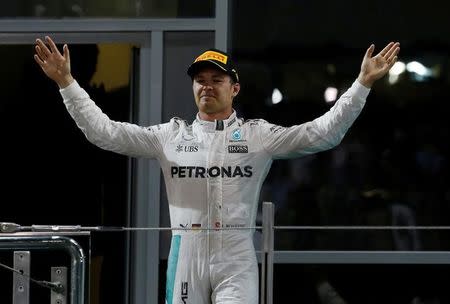 Mercedes' Formula One driver, Nico Rosberg of Germany celebrates after winning the Formula One 2016 Drivers' World Championship . REUTERS/Ahmed Jadallah/File Photo