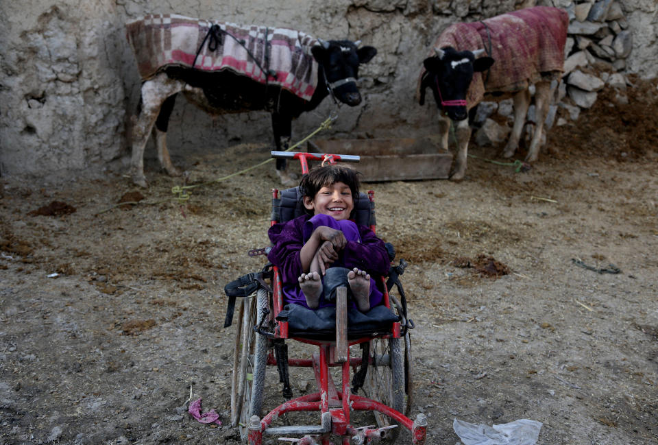 Dil Roba, 10, an Afghan girl, sits on her wheelchair at her temporary home on the outskirts of Kabul, Afghanistan, Friday, Feb. 14, 2014. The war-torn country faces the challenges of poverty, unemployment and a lack of infrastructure. ( AP Photo/Rahmat Gul)