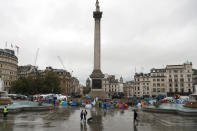 Protestors of the environmental activist group extinction rebellion camp during a demonstration during a rainy morning at Trafalgar Square in London, Monday, Oct. 14, 2019.(AP Photo/Frank Augstein)