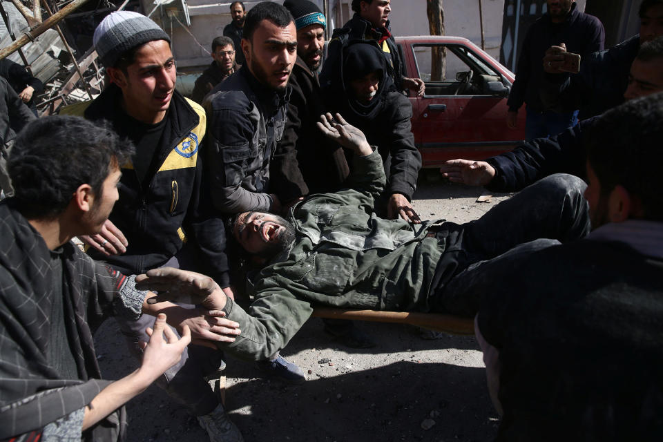 <p>A man reacts as he is carried on a stretcher after an airstrike in the besieged town of Douma in eastern Ghouta in Damascus, Syria, Feb. 7, 2018. (Photo: Bassam Khabieh/Reuters) </p>