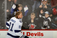 NEWARK, NJ - FEBRUARY 26: Young fans try to get the attention of Steven Stamkos #91 of the Tampa Bay Lightning during warmups prior to the game against the New Jersey Devils at the Prudential Center on February 26, 2012 in Newark, New Jersey. (Photo by Bruce Bennett/Getty Images)