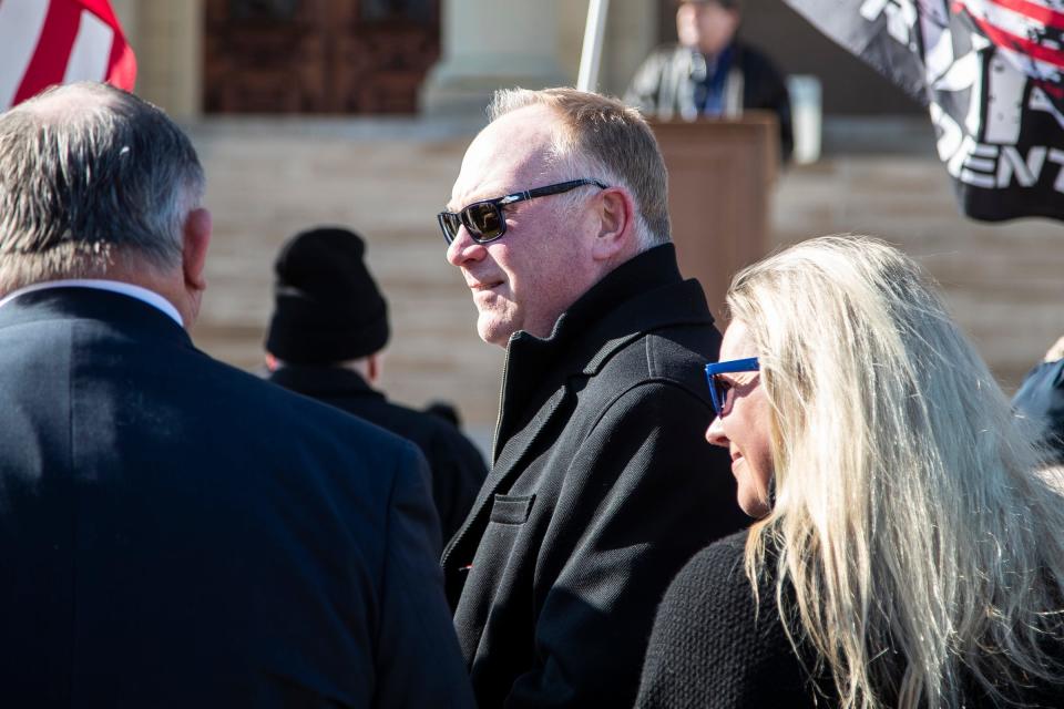 Matt Maddock, center, and Meshawn Maddock, right, talks to talk to State Rep. Bob Bezotte during a protest outside of the Michigan State Capitol in Lansing demanding a forensic audit on Feb. 8, 2022.