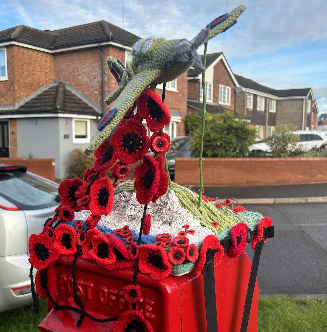 Plane on top of postbox 