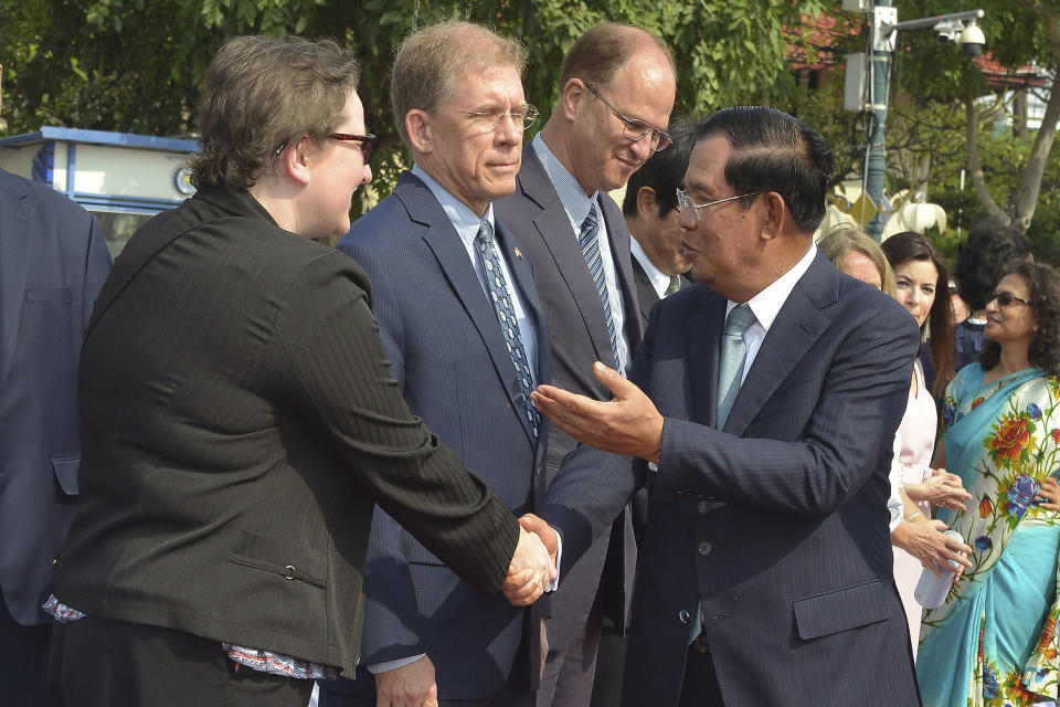 Cambodian Prime Minister Hun Sen, front right, talks in front of U.S. Ambassador to Cambodia W. Patrick Murphy, second from left, during the country's 66th Independence Day from France, at the Independence Monument in Phnom Penh, Cambodia, Saturday, Nov. 9, 2019. The leader of the banned Cambodia National Rescue Party, Sam Rainsy was boarding a fly in Paris for his attempt to return home to challenge his country's longtime autocratic leader as the security inside the country was on high alert and beefed up. (AP Photo/Vithy Soth)