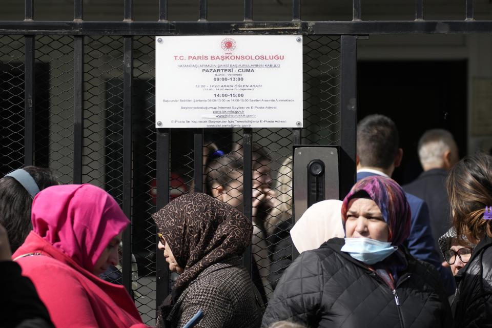 Turkish citizens queue to vote, outside the Turkish consulate, Thursday, April 27, 2023 Boulogne-Billancourt, outside Paris. The voting for the upcoming Turkish election begins on Thursday, with Turkish overseas citizens being the first ones allowed to cast their ballots at embassies and consulates. Turkey votes on Sunday in presidential and parliamentary elections that could extend the increasingly authoritarian President Recep Tayyip Erdogan's two-decades in power or tilt the country toward what his opponents promise to a more democratic one. (AP Photo/Christophe Ena)
