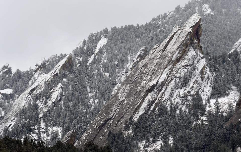 Fresh snow blankets the Flatirons in Boulder, Colo., on Thursday, March 16, 2023. Cloud seeding is a technique used to get clouds to produce more snow and it is being used more as the Rocky Mountain region struggles with a two-decade drought. (AP Photo/Thomas Peipert)