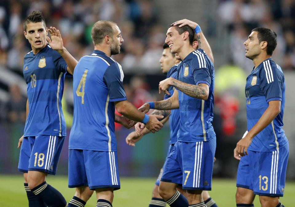 Argentina&#39;s players celebrate their side&#39;s fourth goal by Angel Di Maria, 2nd right, during the friendly soccer match between Germany and Argentina in Duesseldorf, Germany, Wednesday, Sept. 3, 2014. (AP Photo/Frank Augstein)