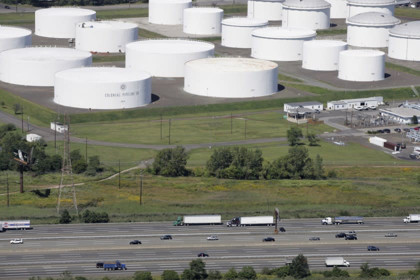 FILE - In this Sept. 8, 2008 file photo traffic on I-95 passes oil storage tanks owned by the Colonial Pipeline Company in Linden, N.J. A major pipeline that transports fuels along the East Coast says it had to stop operations because it was the victim of a cyberattack. Colonial Pipeline said in a statement late Friday that it "took certain systems offline to contain the threat, which has temporarily halted all pipeline operations, and affected some of our IT systems." (AP Photo/Mark Lennihan, File)