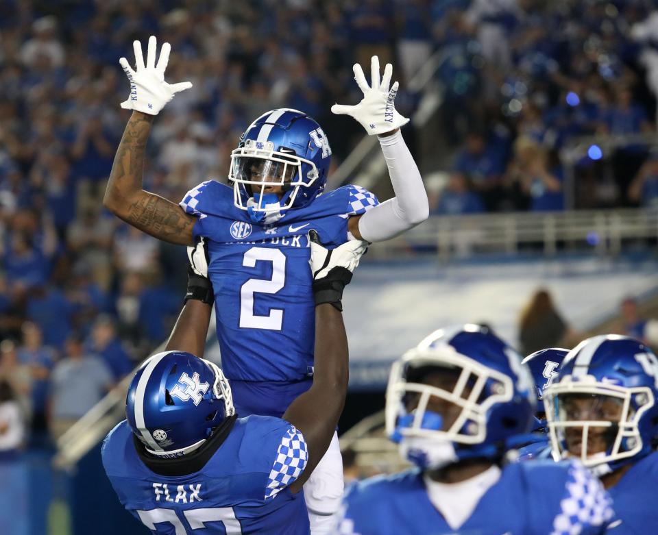 Kentucky’s Barion Brown celebrates, with teammate Jeremy Flax, after scoring a touchdown against Miami of Ohio.Sept. 3, 2022