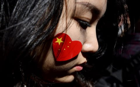 A pro-China activist marches on the streets of Sydney during a rally against ongoing protests in Hong Kong - Credit: &nbsp;SAEED KHAN/AFP