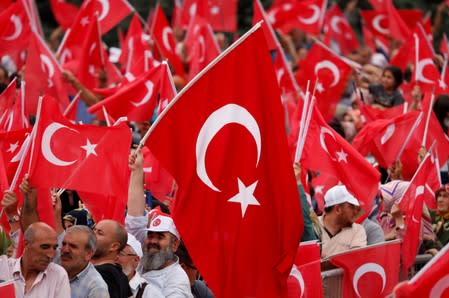 Supporters of Turkish President Erdogan wave Turkish flags during a ceremony in Istanbul