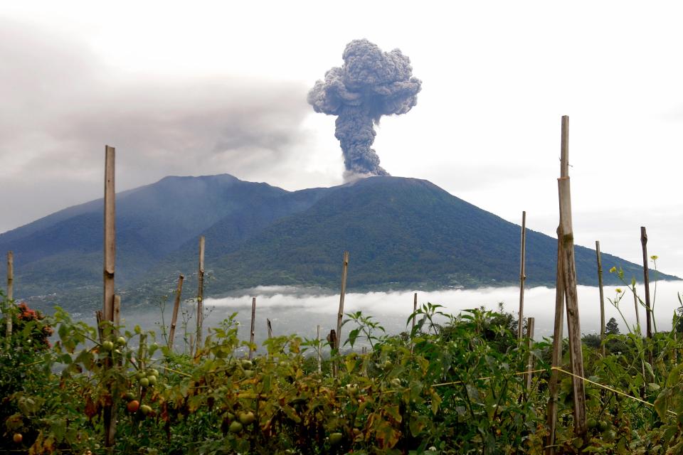 Mount Marapi spews volcanic materials during its eruption in Agam, West Sumatra, Indonesia, Monday, Dec. 4, 2023. The volcano spewed thick columns of ash as high as 9,800 feet into the sky in a sudden eruption Sunday and hot ash clouds spread several miles.