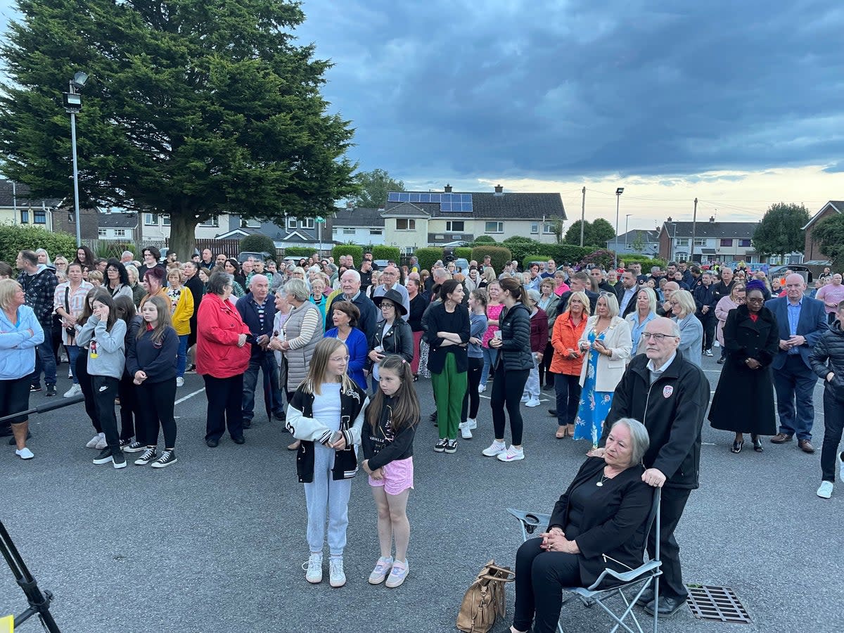 People at St Oliver Plunkett church in Strathfoyle at a vigil for Reuven Simon and Joseph Sebastian (Jonathan McCambridge/PA) (PA Wire)