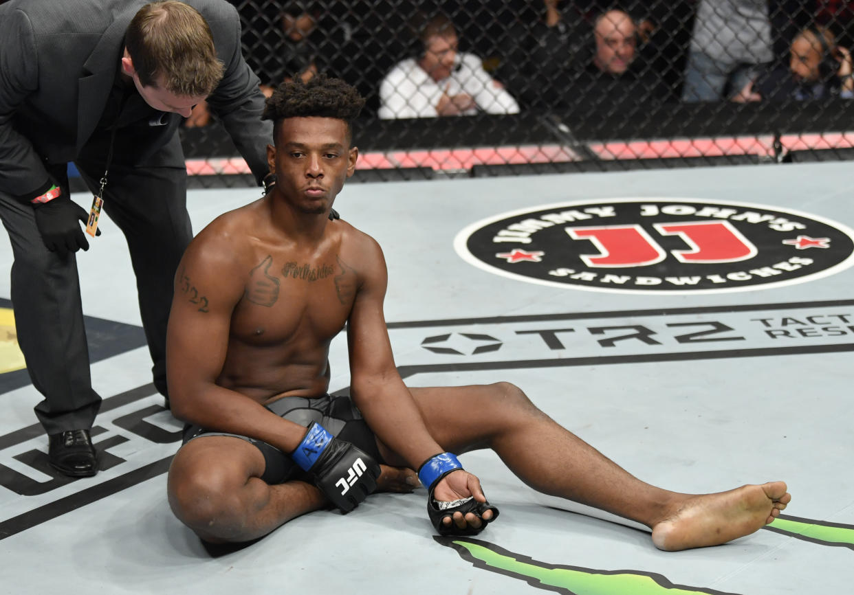 Jamahal Hill reacts after suffering an arm injury against Paul Craig at UFC 263