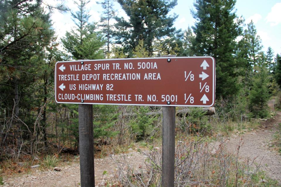 A sign giving directions to trails and U.S. Highway 82 near the Trestle Recreation Area on the Lincoln National Forest.