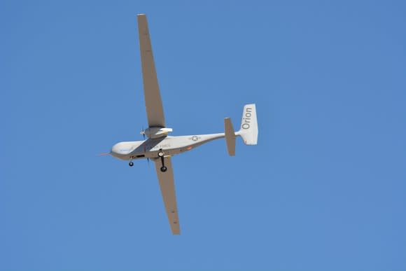 Orion drone in flight against a clear blue sky