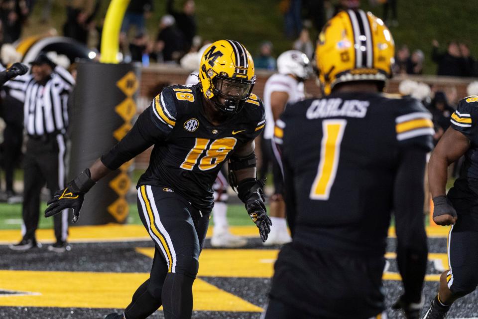 Missouri defensive lineman Trajan Jeffcoat, left, celebrates with teammates after he recovered a fumble for a touchdown against South Carolina on Nov. 13, 2021, at Faurot Field.