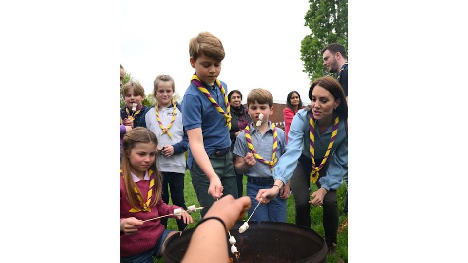 Britain's Princess Charlotte of Wales, Britain's Prince George of Wales, Britain's Prince Louis of Wales and Britain's Catherine, Princess of Wales toast marshmallows as they take part in the Big Help Out