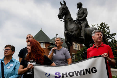 Protesters gather below a monument dedicated to Confederate Major John B. Castleman while demanding that it be removed from the public square in Louisville, Ky., US, August 14, 2017. REUTERS/Bryan Woolston